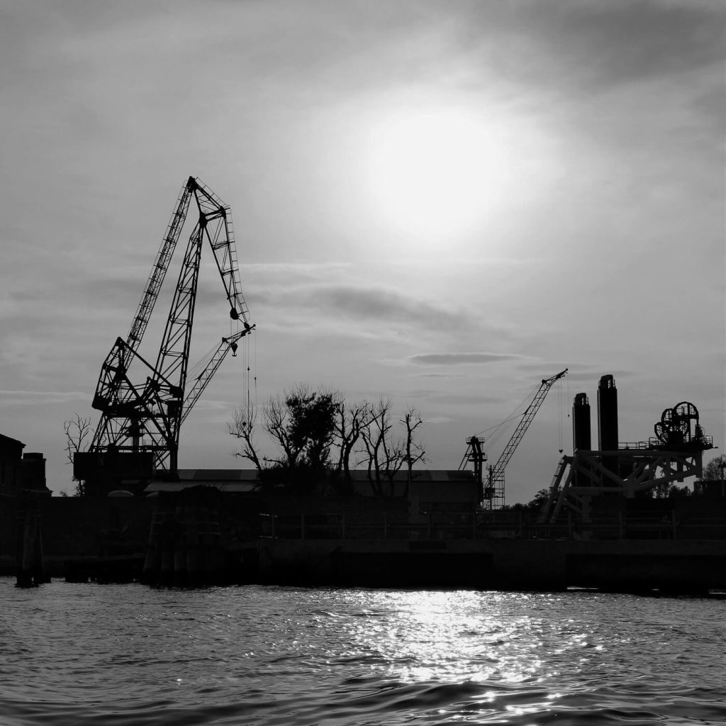 Photo en noir et blanc de grues à Venise, en Italie.